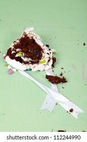 Smashed Up Birthday Party Cake In A Heaped Mess On The Green Floor