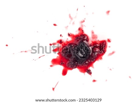 Smashed black currant berries isolated on white background