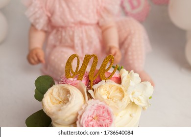 Smashed Cake On White Table For First Birthday Photosession. Messy Pieces. Pink Paper Decorations. Cute Happy Baby Girl Celebrating First Birthday And Eating Birthday Cake. Party Concept