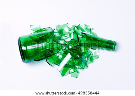 smashed empty bottle lying on a light surface

