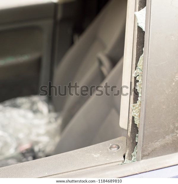 Smashed front door window of\
a car.