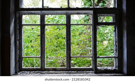 Smashed Glass Window With Old Wooden Frame. Old Window. Finely Broken Glass. Old House, Retro. Cracked Window Frame. Cracked Old Paint, Pieces Of Glass. Close-up, Space For Text. Horror, Halloween