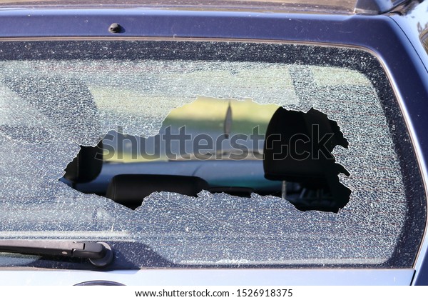 Smashed rear window on\
the back of a car