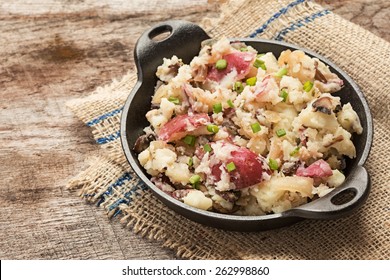 Smashed Red Potatoes With Fried Onions And Mushrooms In Cast Iron Dish