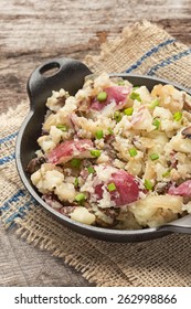 Smashed Red Potatoes With Fried Onions And Mushrooms In Cast Iron Dish