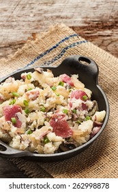 Smashed Red Potatoes With Fried Onions And Mushrooms In Cast Iron Dish