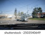 Smashed vehicle windscreen with massive hailstorm damage