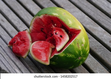 A Smashed Watermelon On A Bench