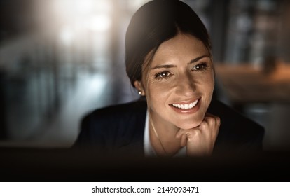 Smashing goals like the pro that she is. Shot of a young businesswoman working online during a late night in a modern office. - Shutterstock ID 2149093471