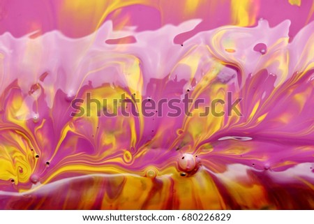Smashing yellow and purple paint background, macro closeup.Texture