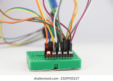 SMD LED or light emitting diodes connected to breadboard using jumper wires and controlled by a micro controller in the background