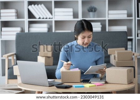 SME businessconcept, young online business shop owner preparing the orders for her customers.