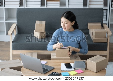 SME businessconcept, young online business shop owner preparing the orders for her customers.