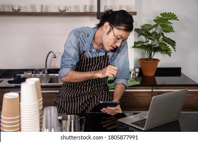 SME Coffee Shop Owner Busy Talking With Beverage Order On Mobile Device