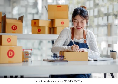 SME Entrepreneur Small Business Entrepreneurs Online Selling Ideas,Happy Young Asian Business Owner Work On Computer And A Boxs At Home,delivery SME Procurement Package Box Deliver To Customers,