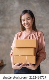 SME Online Seller Young Asian Woman Working On Laptop And Box Checking Online Order, Check Goods Stock Delivery Package Shipping Postal. Asian Woman Startup SME Small Business At Home Office