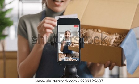 SME owner go green net zero retail store live stream talk on phone showing eco care plastic free packaging box Asia people young woman record video on   reel  shop happy side hustle