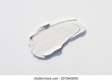 A smear of cream or face mask. The appearance of the texture of the cream on white background. Skincare products , natural cosmetic. Beauty concept for face and body care - Shutterstock ID 2073642050