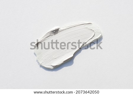 A smear of cream or face mask. The appearance of the texture of the cream on white background. Skincare products , natural cosmetic. Beauty concept for face and body care