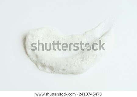 Smear of facial cleansing foam on white background close up.