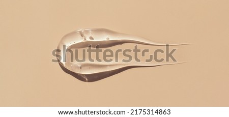 smear gel serum on pastel beige background