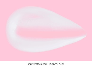 A smear of greasy. cream on a pink background.  - Shutterstock ID 2309987021
