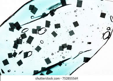 Smear Paint Of Cosmetic Products On A White Background, Micro Beads Particles In Blue Transparent Toothpaste