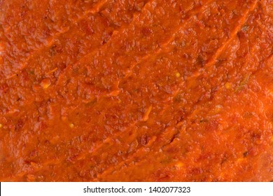 Smeared Ajvar Or Pindjur Orange Vegetable Spread Texture Made From Bell Peppers, Eggplants And Oil. Marinara Sauce Smear, Salsa, Chutney Or Lutenica Background Or Pattern Top View