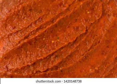 Smeared Ajvar Or Pindjur Orange Vegetable Spread Texture Made From Bell Peppers, Eggplants And Oil. Marinara Sauce Smear, Salsa, Chutney Or Lutenica Background Or Pattern Top View