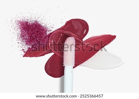 Smears composition of shining red lip gloss and  lip gloss brush isolated on white background                               