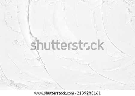 Smears of white plaster texture. Putty strokes pattern. Abstract light background