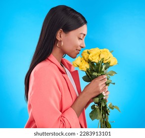 Smell, flowers and bouquet with woman in studio for gift, satisfaction and spring. Relax, happy and floral present with female and roses isolated on blue background for aroma, natural and products - Powered by Shutterstock