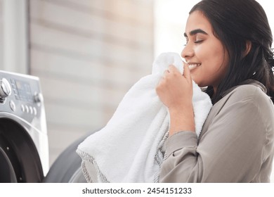 Smelling, cleaning or happy woman with laundry, machine and home for clothes, fabric and housekeeping. Scent, female person and cleaner washing items in laundromat with routine, smile and service - Powered by Shutterstock