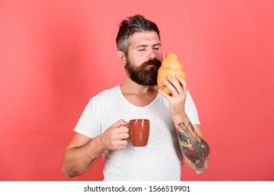 smells good. Fresh baked croissant. Delicious breakfast. Unhealthy but yummy breakfast. Perfect match. feel hunger. Bearded hipster enjoy breakfast drink coffee. Morning tradition concept.