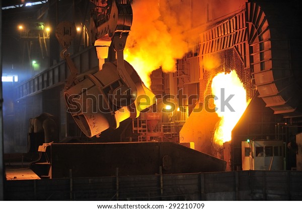 smelting of\
the metal in the foundry at steel mill\
