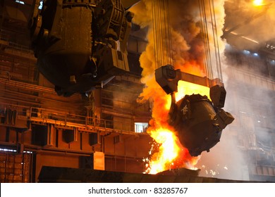 Smelting metal in a metallurgical plant. Liquid iron from the ladle - Powered by Shutterstock