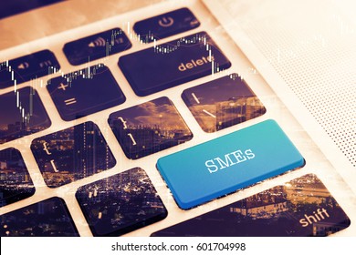 SMEs (SMALL AND MEDIUM-SIZED ENTERPRISES): Close up green button keyboard computer. Vintage Effects. Digital Business and Technology Concept.
