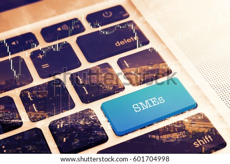 SMEs (SMALL AND MEDIUM-SIZED ENTERPRISES): Close up green button keyboard computer. Vintage Effects. Digital Business and Technology Concept.