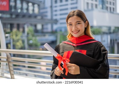 Smile Asian Student Graduate Hand Holding Diploma.