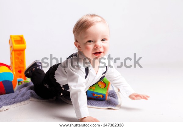 Smile Boy\
crawling with toys over white\
background