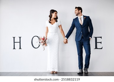 Smile, bride and groom holding hands in new home for support, love or bouquet. Newlywed couple, man or woman in house together for marriage, wedding or mortgage investment on white wall background - Powered by Shutterstock