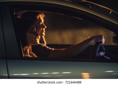 The Smile Couple Drive A Car. Evening Night Time