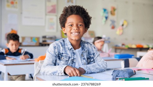 Smile, education and writing with boy in classroom for learning, knowledge and study. Scholarship, happy and future with portrait of young student at school for academy, exam test and project - Powered by Shutterstock