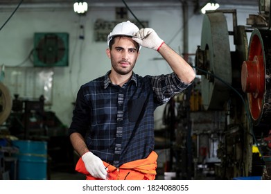 smile engineer checking and inspects quality of industrail machine in factory with confident 
