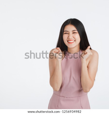 Smile face of beautiful black long hair young Asian woman in pink dress. Girl pose in feeling very happy amazed excited and surprised, studio light portrait shot isolated on white background.