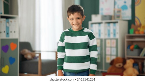 Smile, face and child in classroom for studying, learning and ready for morning kindergarten. Happy, school and portrait of boy or student with knowledge, education and pride for academic lesson - Powered by Shutterstock