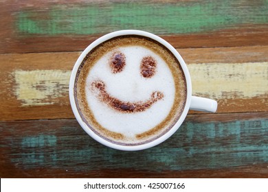 Smile Face Drawing On Latte Art Coffee , Wood Color Background