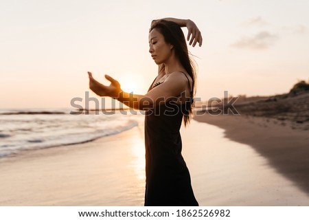 Smile Freedom and happiness chinese woman on beach. She is enjoying serene ocean nature during travel holidays vacation outdoors. asian beauty. summer time