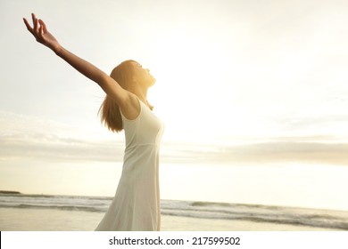 Smile Freedom And Happiness Woman On Beach. She Is Enjoying Serene Ocean Nature During Travel Holidays Vacation Outdoors. Asian Beauty