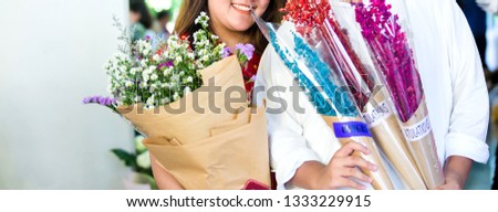 The smile of a girl with a bouquet of flowers